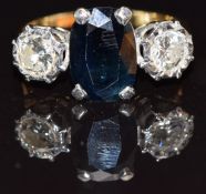 An 18ct gold ring set with an oval cut sapphire and two diamonds each approximately 0.3cts, size