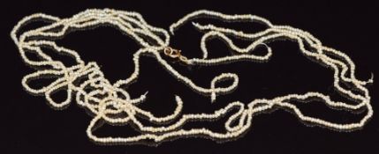 A three strand seed pearl necklace with 9ct gold clasp