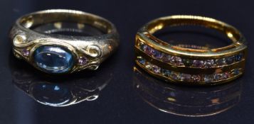 Two 9ct gold rings, one set with a topaz cabochon and pink sapphires the other with sapphires,