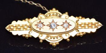 Victorian 15ct gold brooch set with three old cut diamonds in star settings, Birmingham 1896, 4.4g