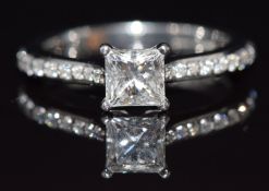 A platinum ring set with a princess cut diamond of approximately 0.7ct with further diamonds to