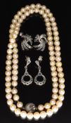A single strand of cultured pearls and two pairs of silver earrings set with marcasite