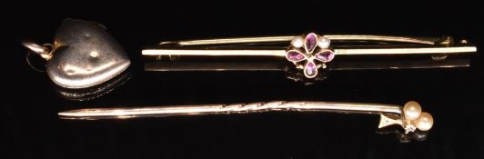 A 9ct gold brooch set with garnets and seed pearls (1.8g), a yellow metal stick pin and a heart