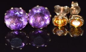 A pair of 9ct gold earrings set with a yellow sapphire to each and a pair of 9ct gold earrings set