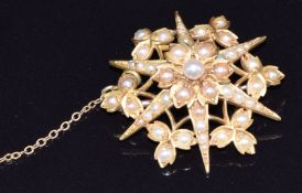 Edwardian 9ct gold brooch set with seed pearls in a stylised star and floral design, 6.4g