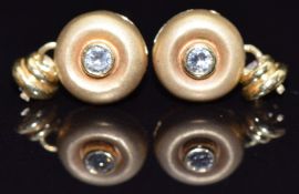 A pair of 18ct gold earrings set with a diamond to each, 2g