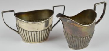 Edward VII hallmarked silver milk jug and sugar bowl with reeded lower bodies, Chester 1901, maker