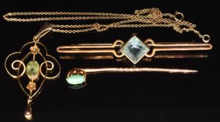 Edwardian 9ct gold pendant set with a peridot on 9ct gold chain, a 9ct gold stick pin set with a