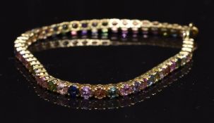 A 9ct gold bracelet set with multi coloured sapphires, 10.6g