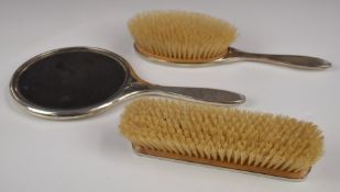 Art Deco hallmarked silver dressing table set comprising hand mirror and two brushes, Birmingham