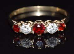 A 9ct gold ring set with garnets and cubic zirconia, size P, 1.8g