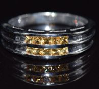 A 9k white gold ring set with yellow sapphires, size M/N, 3.5g