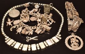 Silver charm bracelet with over 25 silver charms, bracelet, pendants and a paste necklace, 122g