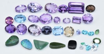 A collection of amethysts, black opal doublet, emerald, etc