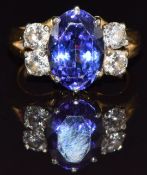 An 18ct gold ring set with an oval tanzanite and four diamonds, each approximately 0.2ct, size K,