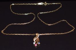 A 9ct gold pendant set with sapphires and a ruby (1.1g) on a 18ct gold chain made up of