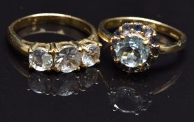 A 9ct gold ring set with an aquamarine and tanzanites and a 9ct gold ring set with zircons, size N,