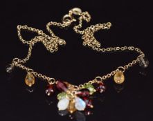 A 9ct gold necklace set with briolette cut garnets, peridot and quartz, 7.7g