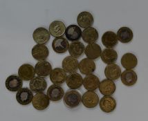 A collection of £2 coins, largely single metal, around 40 in all, together with a quantity of NHS
