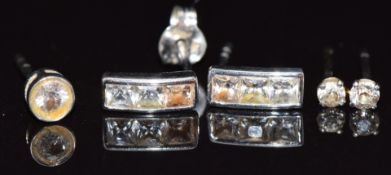 A pair of 9ct white gold earrings, a pair of white gold earrings set with a diamond to each and a