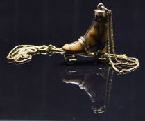 A 15ct gold necklace/ chain and a Victorian pendant set with a carved bone roller skate marked