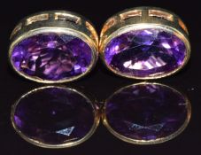 A pair of 9ct gold earrings set with an oval cut amethyst to each, 7.6g