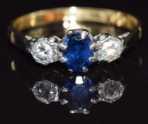 An 18ct gold ring set with an oval cut sapphire and diamonds, size M, 2.3g