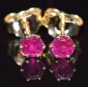 A pair of 18ct gold earrings set with natural unheated Burmese rubies (total 0.27cts), with GCS