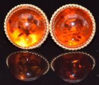 A pair of 9ct gold earrings set with pressed amber cabochons, 3g