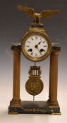 French Empire Portico clock mounted on reeded brass Roman columns and marble base, surmounted by