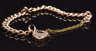 A 9ct rose gold curb link bracelet with heart clasp/ padlock, 11.6g