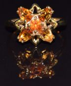 A 9k gold ring set with citrine and garnets, size N, 3.1g