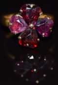 Victorian 22ct gold ring set with four heart shaped garnets forming a four leaf clover, in vintage