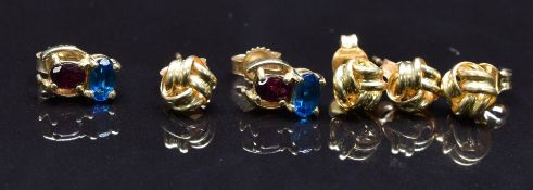 Two pairs of 9ct gold knot earrings and a pair of 9ct gold earrings set with an apatite and garnet