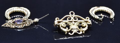 A pair of 9ct gold earrings and a single 9ct gold earring (2.5g) and a yellow metal brooch