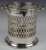 George V hallmarked silver twin handled wine bottle coaster or holder, with pierced lattice