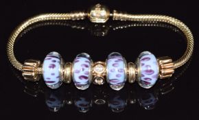 A 14ct yellow gold Pandora bracelet, the snake link chain suspending four 14ct gold and Murano glass