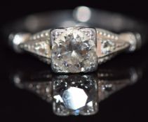 A platinum ring set with a diamond of approximately 0.5ct and two further diamonds to the shoulders