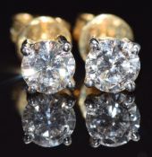 A pair of 18ct gold earrings set with a diamond of approximately 0.5ct to each, 2g