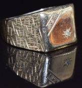 A 9ct gold signet ring set with diamonds and textured decoration to the shoulders, size T/U, 7.5g