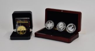 Cased coin set comprising 2011 1oz silver Britannia and two silver dollars, together with a cased