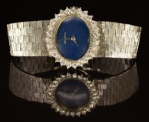 Swiss 14ct gold ladies wristwatch with silver hands, blue dial, diamond set bezel and 17 jewel