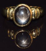 A 9k gold ring set with a synthetic black star sapphire, size N, 5g