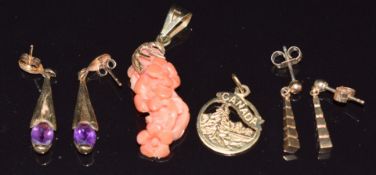 A 9ct gold pendant set with carved coral, two pairs of 9ct gold earrings, one set with an amethyst