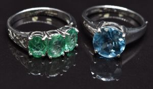 Two 9ct white gold rings, one set with emeralds and the other blue topaz, size N, 7.2g