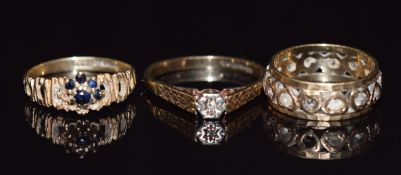 Three 9ct gold rings, one set with a diamond, 7.2g
