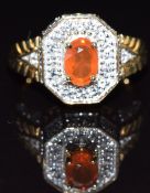 A 9k gold ring set with an oval cut fire opal and topaz, size N, 6.5g