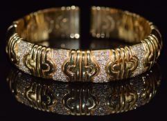 An 18ct gold bangle/ bracelet set with sections of diamonds, 70.4g