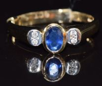 A 9ct gold ring set with an oval cut sapphire and diamonds, size N, 2.9g