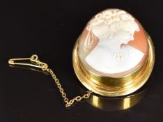 A 9ct gold brooch set with a cameo depicting a young woman